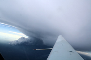 convective system producing the anvil can also be seen just below the wing of the aircraft.