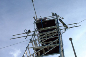 Looking up the tower at the ADA head and other instruments during NAMBLEX. This view emphasises the usefulness of having a small probe head linked to the rather bulky laser, optical bench and data system shown below, by fiber optics. Thus allowing the data system etc to be located well out of the way in a trailer at the base of the tower.